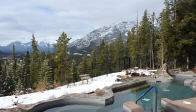 A hot tub with a view of a mountain range