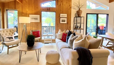 A cozy living room with a couch and chairs