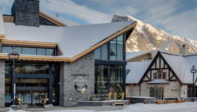 A hotel building with a mountain in the background