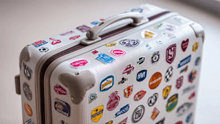 okiescookies-high-definition-image-of-a-suitcase-covered-with-d1a68320-9455-4793-aca0-fce8bc11485f-0