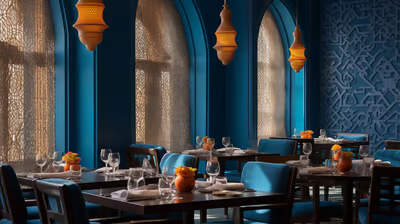 a restaurant with blue chairs and a table with glasses a restaurant with blue chairs and a table with glasses