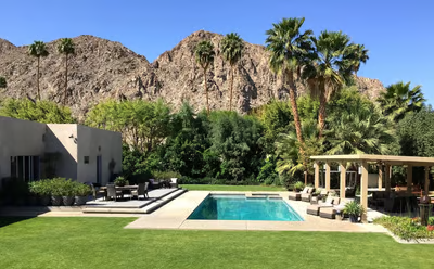a pool with a mountain in the background