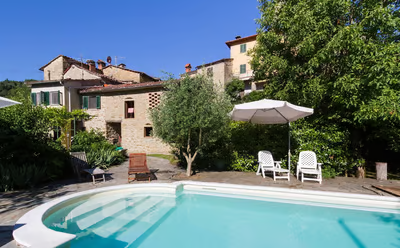 a house with a pool and garden