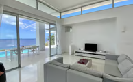 a living room with a large window and a view of the ocean