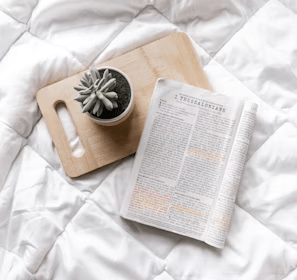 white book page on brown wooden chopping board
