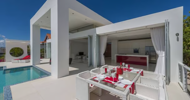 a view of the pool with a dining table