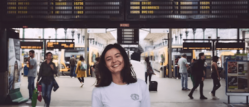 woman in white crew neck t-shirt standing on white floor tiles