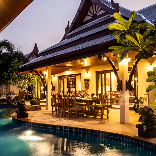 A villa house with a pool and a patio area A villa house with a pool and a patio area