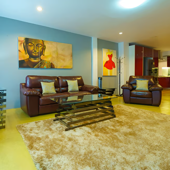 A pool with lounge chairs outside a villa A pool with lounge chairs outside a villa