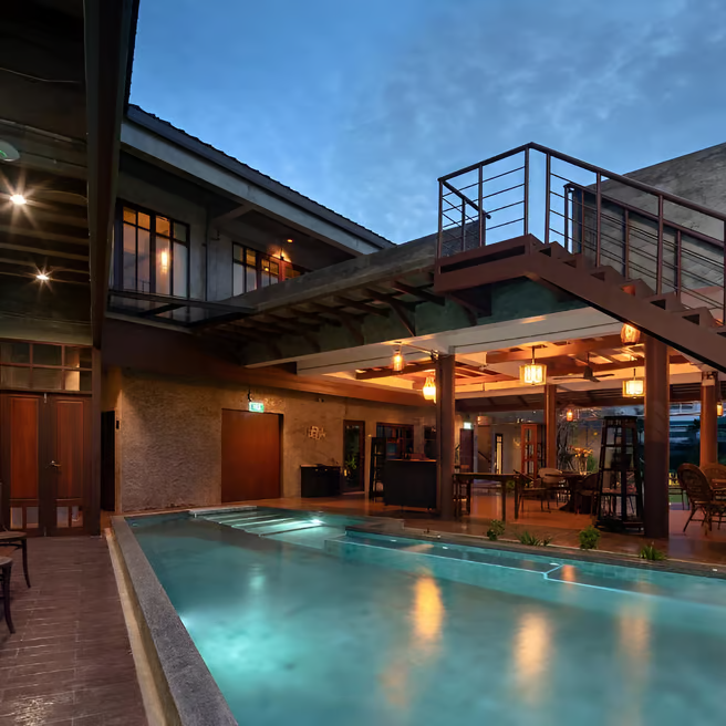 A pool with a staircase leading to a deck A pool with a staircase leading to a deck