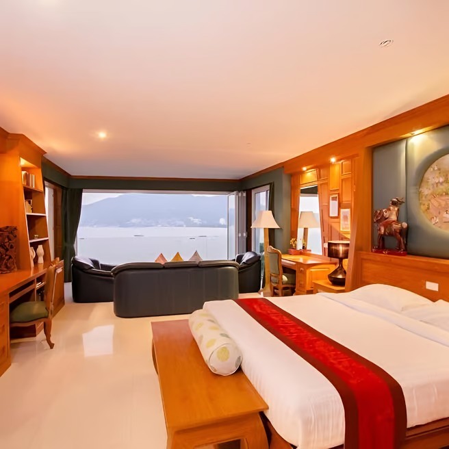 A bedroom with a large bed overlooking the beach A bedroom with a large bed overlooking the beach