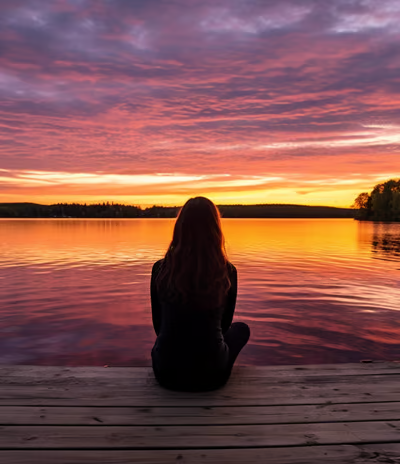 A lady relaxing on a dock overlooking Balsam Lake in Ontario, Canada during sunset. A lady relaxing on a dock overlooking Balsam Lake in Ontario, Canada during sunset.