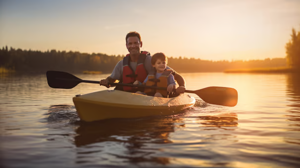 Father and son kayaking the calm waters of Balsam Lake in Ontario, Canada. Father and son kayaking the calm waters of Balsam Lake in Ontario, Canada.