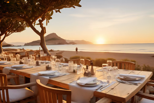 A beachfront table setting during a sunset A beachfront table setting during a sunset