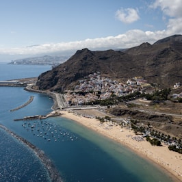 Aerial view of Tenerife beach and town, showcasing beautiful coastline and urban landscape.