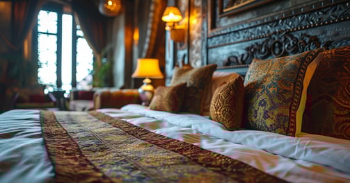 a bed with a large bed and lamps