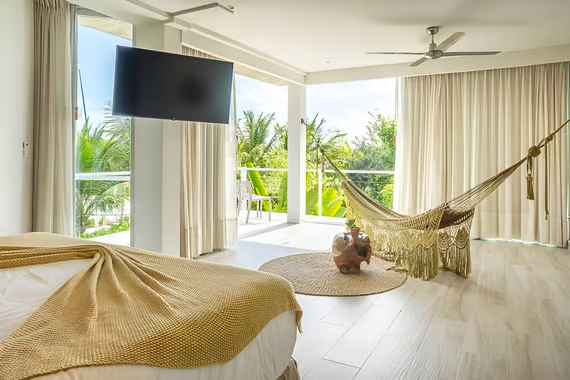 A bedroom with a hammock inside in playa del carmen A bedroom with a hammock inside in playa del carmen