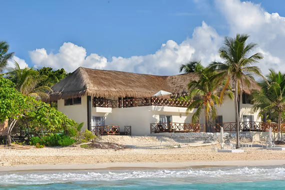 A beach house with a thatched roof in playa paraiso A beach house with a thatched roof in playa paraiso