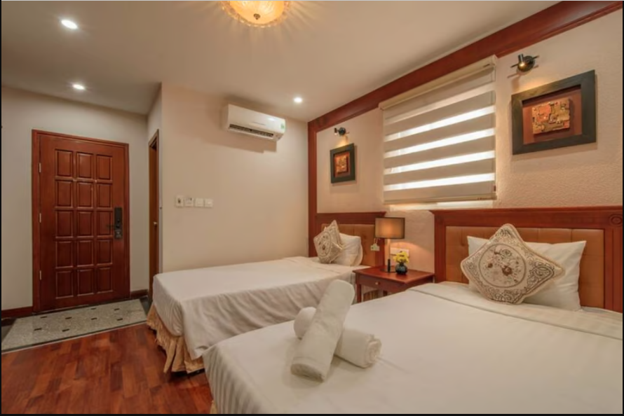 A vietnam hotel bedroom with two beds
