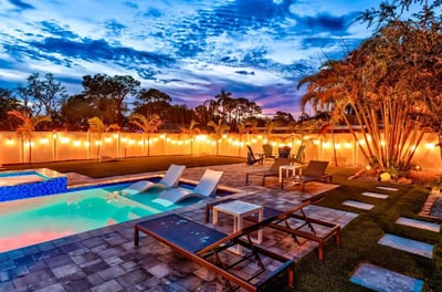 Twilight Retreat: A Backyard Oasis Glows Under a Dramatic Sky.