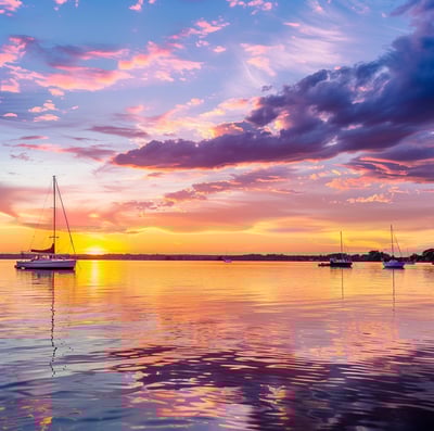 a sunset with sailboats in the water in Madison, Wisconsin