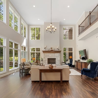 a large living room with a fireplace and a large window in in Madison, Wisconsin