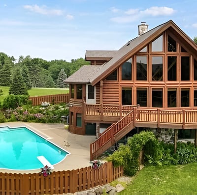 a pool in front of a cottage