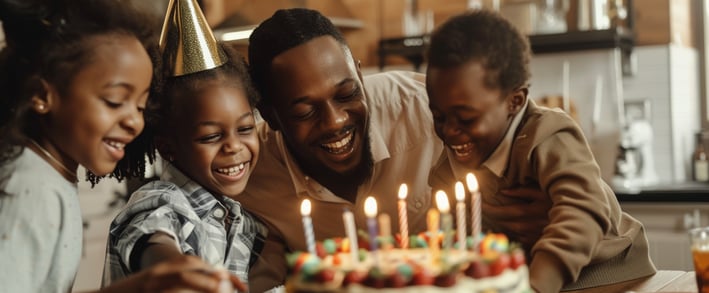 a family of four having a birthday party in the kitchen of a luxurious home rental.