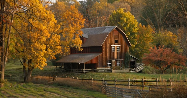 Rustic barn-style house amidst a vibrant autumn landscape, radiating warm colors and a pastoral atmosphere.