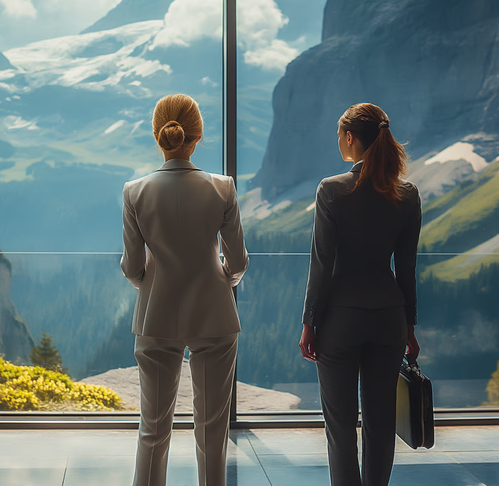 two women standing in front of a mountain view