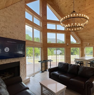 A living room with a large window and a fireplace of a farmhouse in Virginia