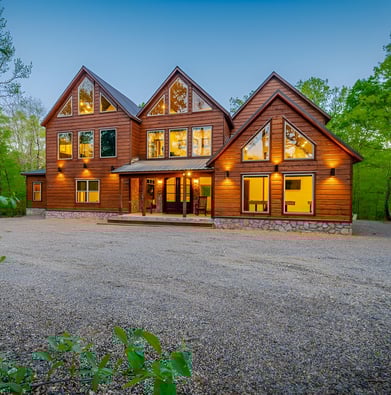 A large wooden house with a large driveway in Oklahoma