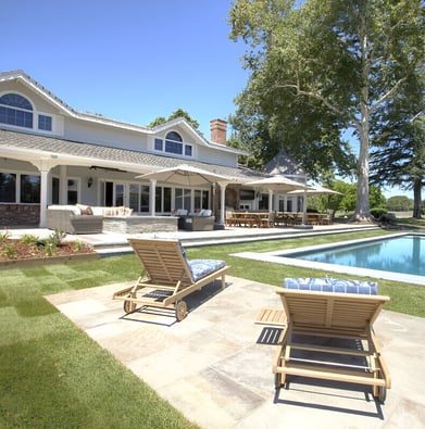 A large house with a pool and lounge chairs in California