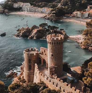 A castle like structure with a tower in the middle at Tossa de Mar, Spain