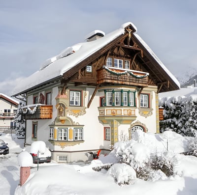 a house with a snow covered roof in innsbruck, austria