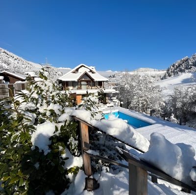 a house with a pool covered with snow in innsbruck, austria