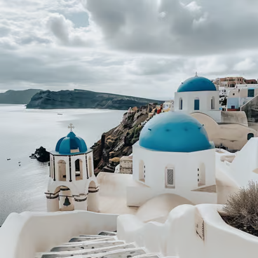 Iconic whitewashed buildings and blue-domed churches of Santorini, Greece Iconic whitewashed buildings and blue-domed churches of Santorini, Greece