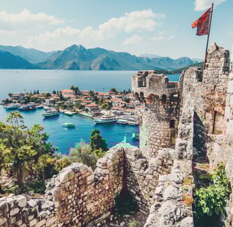 a flag flying over a castle like structure in marmaris, turkey a flag flying over a castle like structure in marmaris, turkey