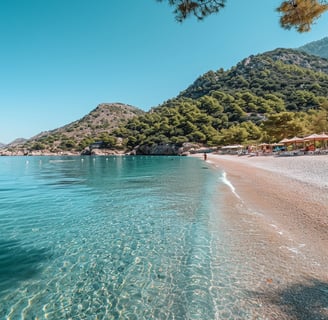 a beach in marmaris, turkey with a mountain in the background a beach in marmaris, turkey with a mountain in the background