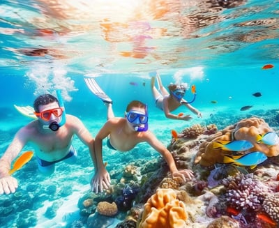 Family snorkeling among vibrant coral and fish at Looe Key National Marine Sanctuary, showcasing the