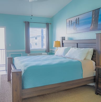 a bedroom with a bed and a dresser