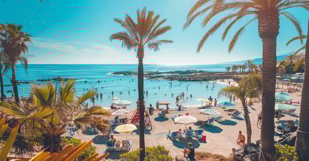 Sunny beach view from a balcony with palm trees. Sunny beach view from a balcony with palm trees.