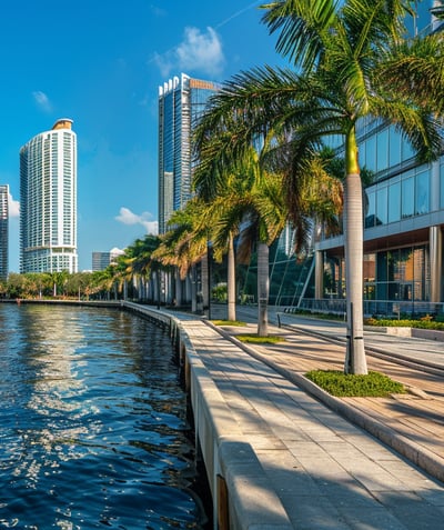 Waterfront promenade with palm trees and a modern architectural structure. Waterfront promenade with palm trees and a modern architectural structure.