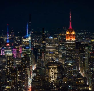 The Empire State Building illuminated in red and blue lights at night