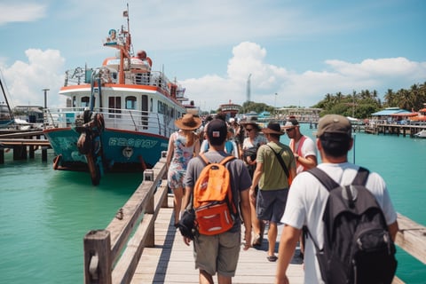 Tourists strolling on pier with boat in background.