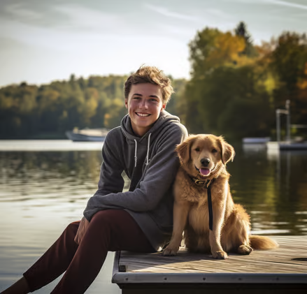 a young man and his dog sitting on the dock and posing for a picture in Bass Lake, CA a young man and his dog sitting on the dock and posing for a picture in Bass Lake, CA
