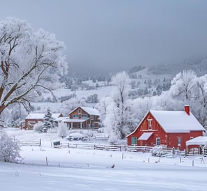 Red barn in snow next to farm, winter scene with rustic charm