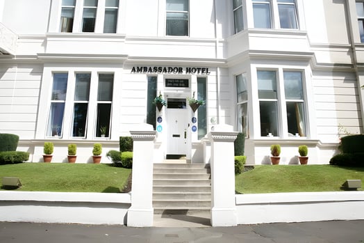 the entrance of a white painted hotel in west end glasgow