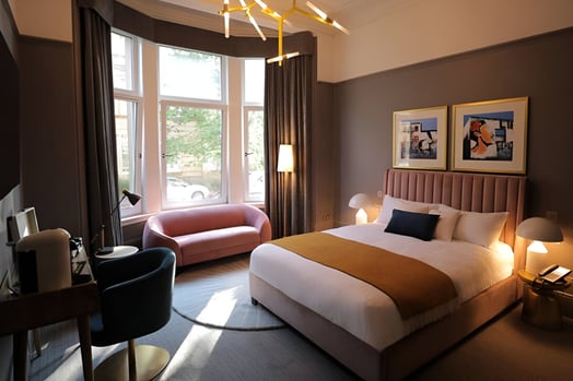 a bedroom with a bed and a couch in west end glasgow