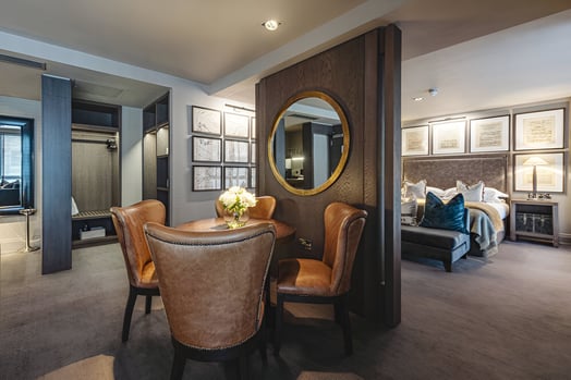 a living room with a table and chairs of a hotel in merchant city glasgow